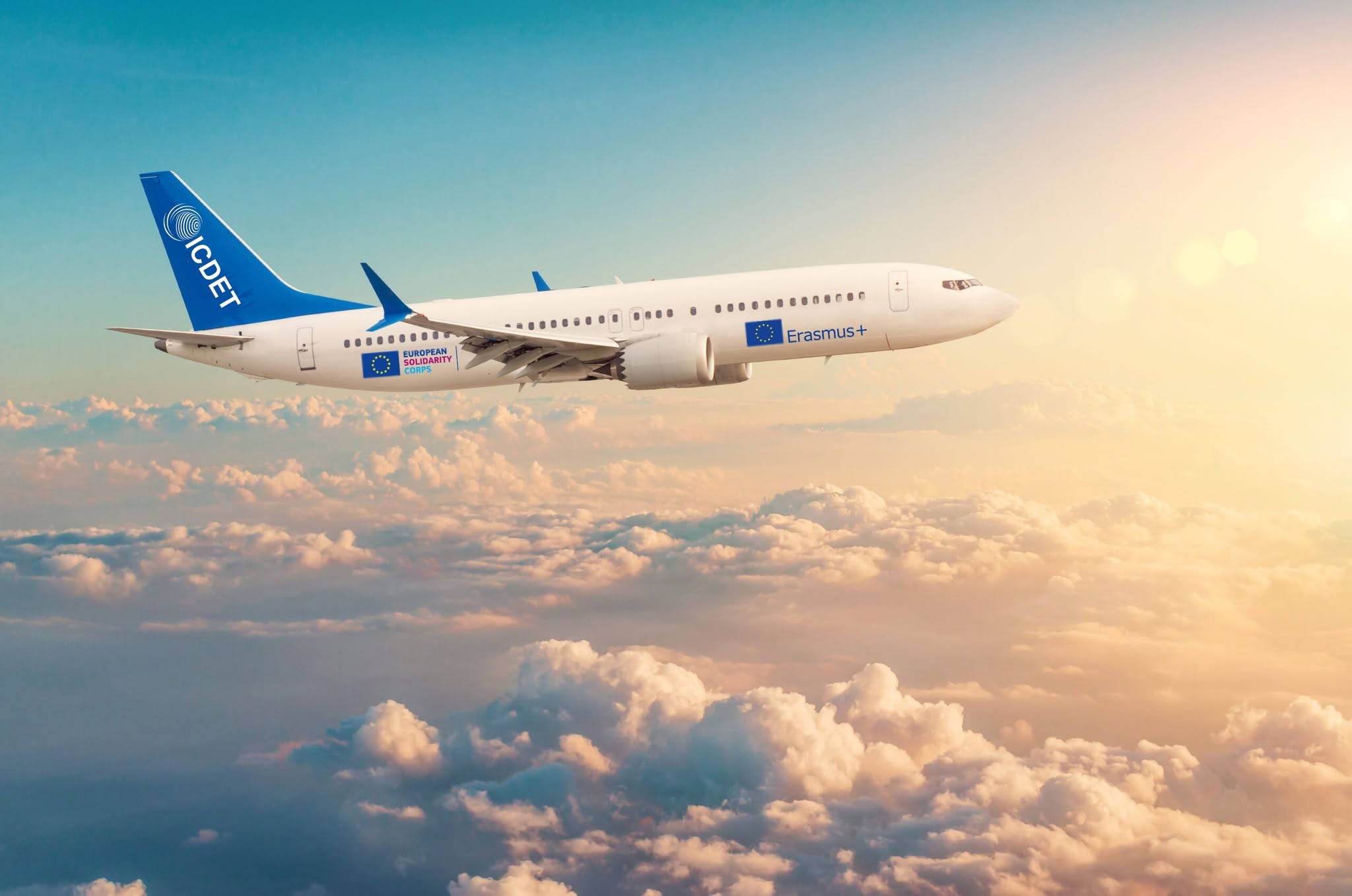 Commercial airplane flying above cloudscape in dramatic toned sunset light. Commercial airplane flying above cloudscape in dramatic toned sunset light.
